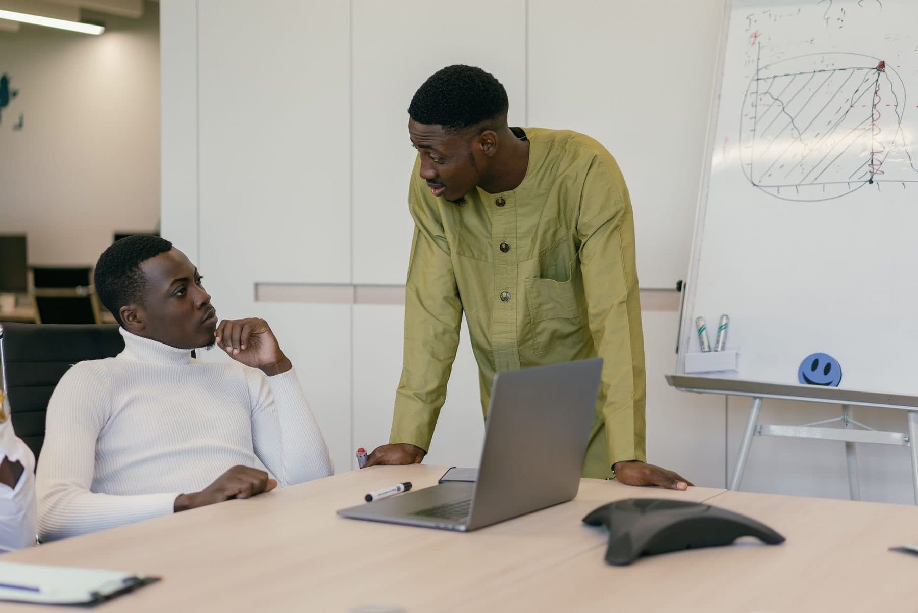 Colleagues reviewing systems on a laptop